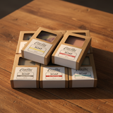 Collection of soap bars in cardboard packaging on a wooden surface