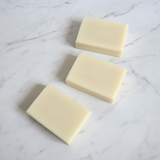 Three bars of soap on a marble surface