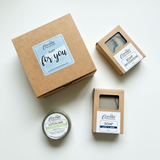 Set of soap and lotion bars in cardboard packaging on a white background