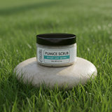 Jar of pumice scrub on a stone in a grassy field